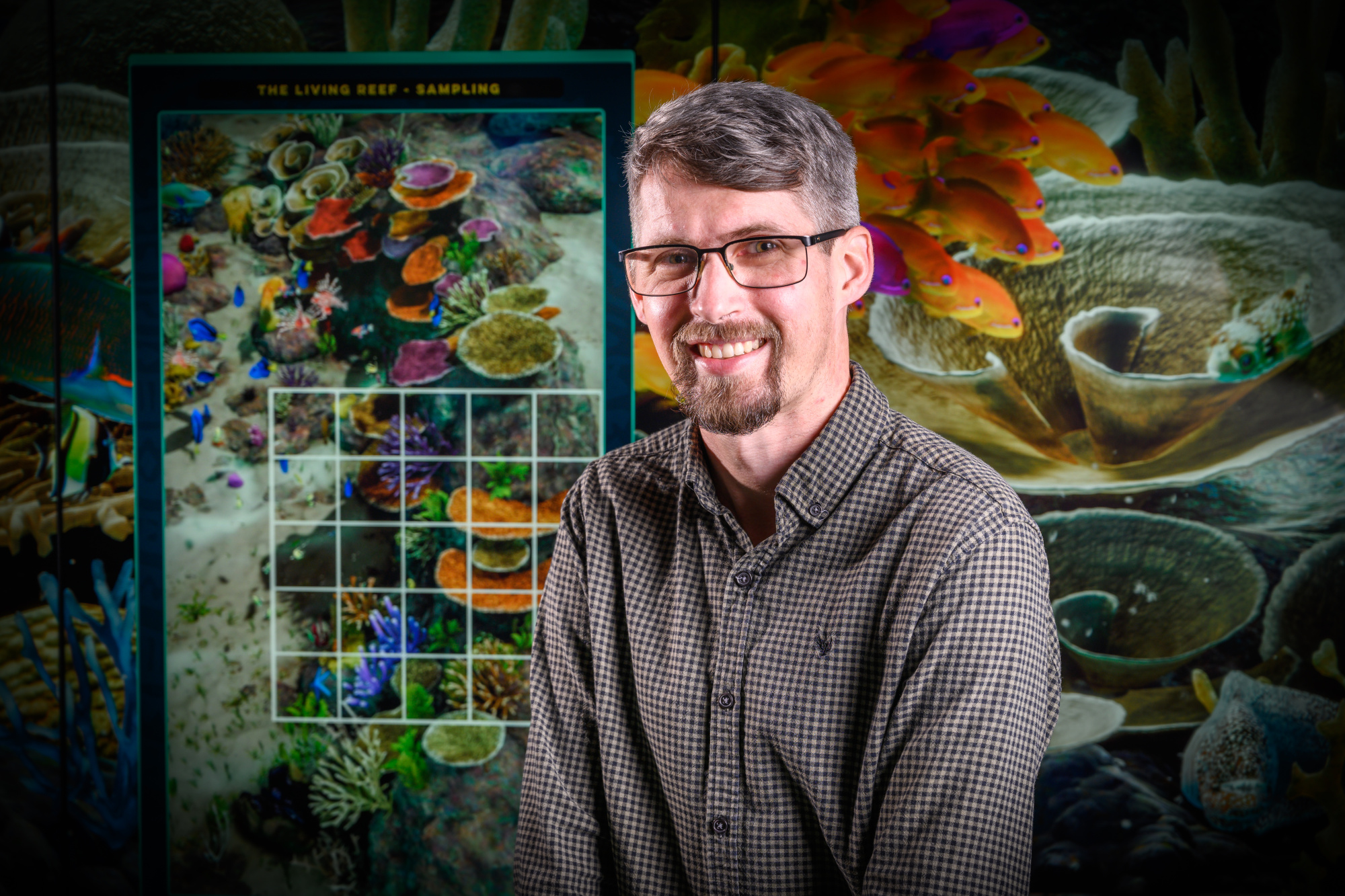August 16, 2021. Centre for Data Science HDR scholarship recipient David Warne pictured in front of the Reef Display at the Cube, P-Block, Gardens Point. Image for HDR scholarship campaign.