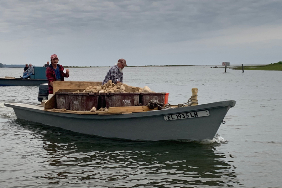 Local oyster harvesters help deploy limestone rock, a restoration material, for the Apalachicola Bay System Initiative oyster reef restoration experiments. (Courtesy of FSU Coastal and Marine Laboratory)